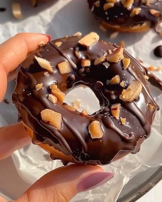 Chocolate Apple Doughnuts topped with chocolate glaze and apple slices.
