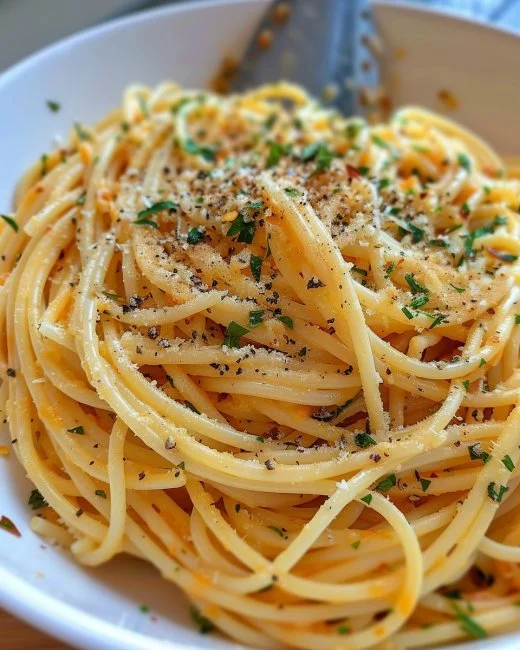Garlic Butter Pasta 2 Delicious garlic butter pasta garnished with parsley and parmesan cheese.