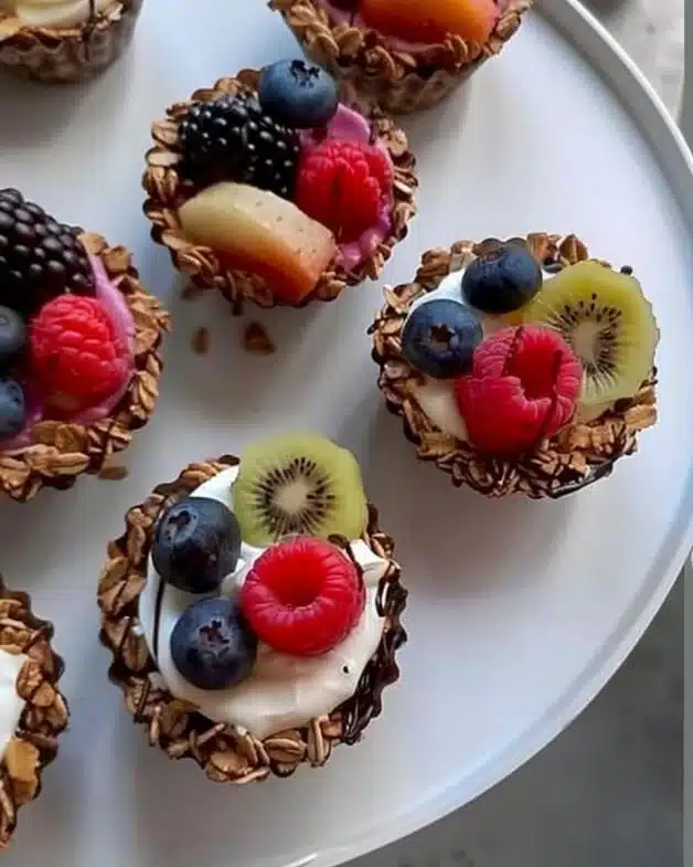 Granola Cups with Yogurt and Fruits 2 Granola cups topped with yogurt and fresh fruits for a healthy snack.