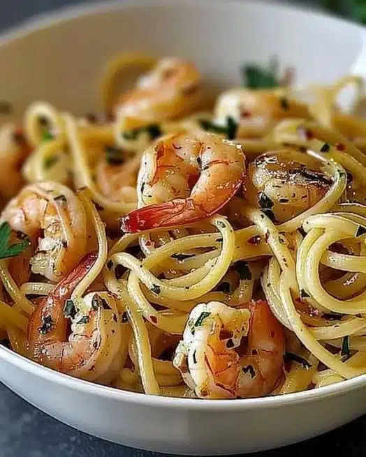 One-Pot Garlic Butter Shrimp Pasta 2 A bowl of one-pot garlic butter shrimp pasta garnished with parsley and lemon.