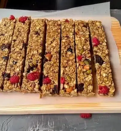 Vegan Granola Bars 2 Homemade vegan granola bars with nuts and seeds displayed on a wooden table
