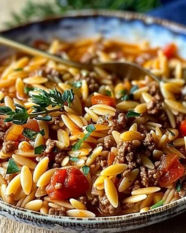 Delicious Ground Beef Orzo served in a bowl with herbs and spices.