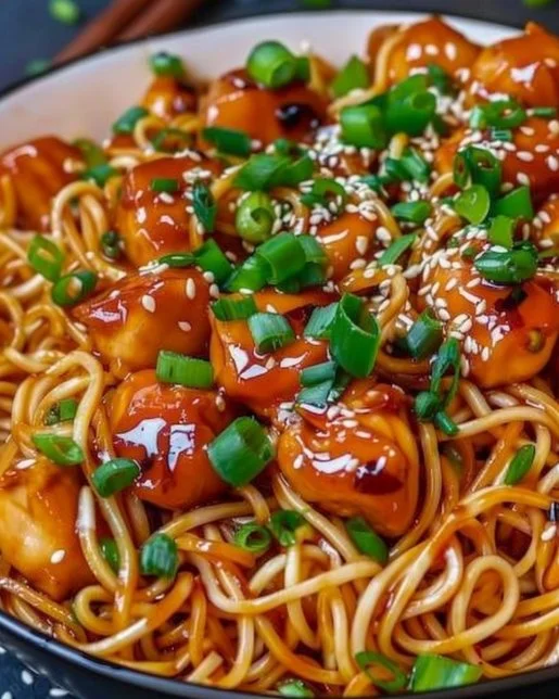 Sticky Garlic Chicken Noodles 2 Plate of sticky garlic chicken noodles garnished with scallions