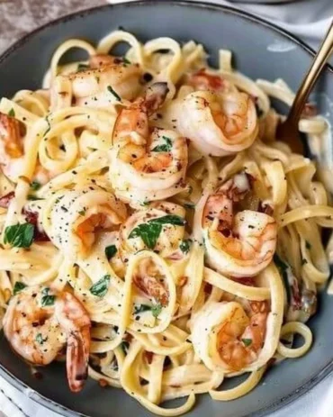 Delicious creamy Tuscan shrimp linguine served with fresh herbs and garlic.