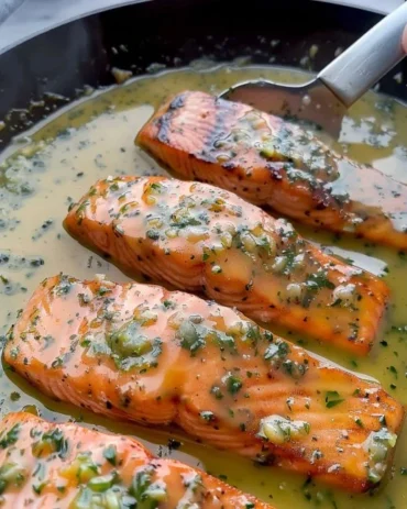 Deliciously cooked salmon fillet drizzled with garlic butter sauce