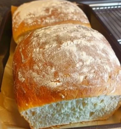 Loaf of homemade white bread fresh out of the oven.