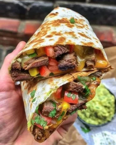 Delicious loaded steak quesadillas with melted cheese and toppings