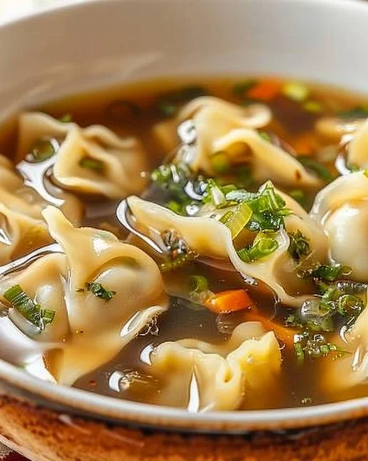 Bowl of savory Potsticker Soup with dumplings and green onions
