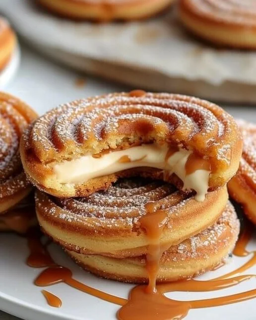 Stuffed Mexican churro cookies with caramel drizzle on a plate.