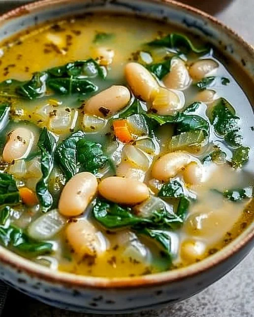 White Bean and Spinach Soup 2 Bowl of white bean and spinach soup garnished with herbs